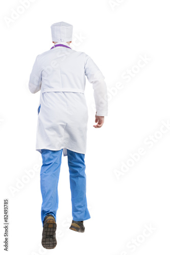 Back view of running doctor in a robe hurrying to help the patie photo