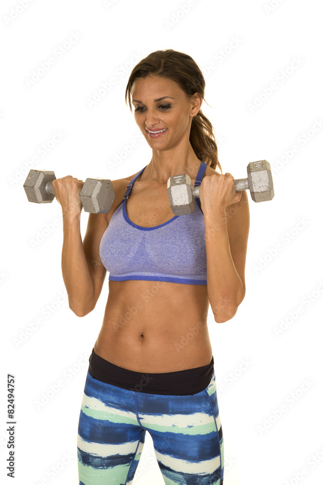 woman in blue fitness outfit curl both weights woman in blue fitness outfit curl both weights