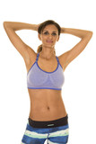 woman in blue fitness outfit hands behind head