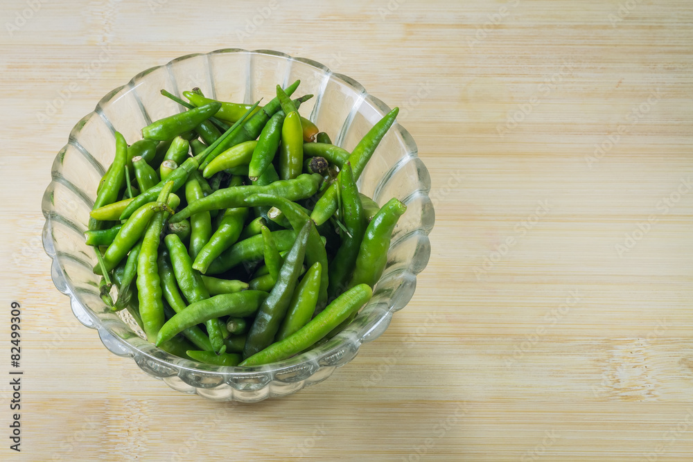 green pepper in bowl over wooden background green pepper in bowl over wooden background