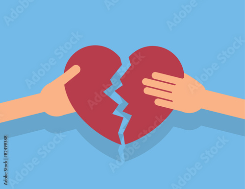 Hands breaking apart a large heart