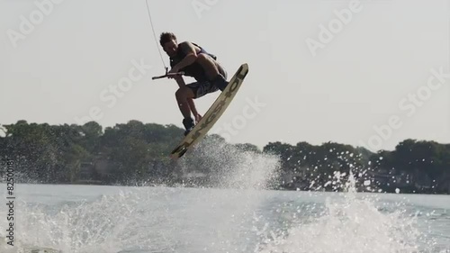 USA, Florida, Orlando, Maitland Lake, Young man doing trick on wakeboard