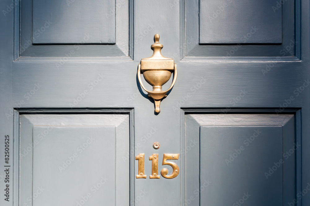 Obraz premium Door number one hundred and fifteen and knocker vignette look