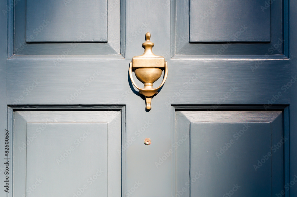 Fototapeta premium Background of vintage blue painted door and knocker vignette