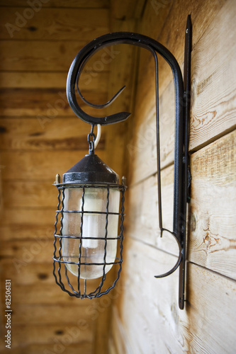 Retro lamp on a wooden wall