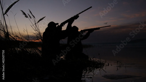 two hunters throwing shooting at the same time