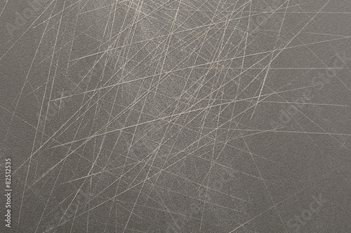 Grey plastic chopping board with deep scratch by knife