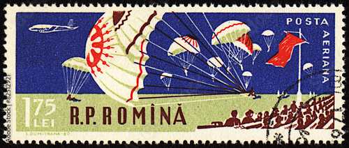 Parachutists landing in stadium  on post stamp