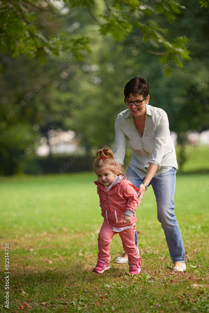happy family playing together outdoor in park happy family playing together outdoor in park