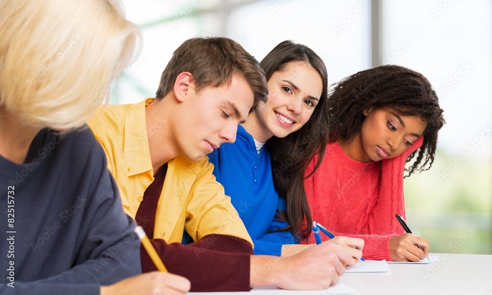 Schooling. Students writing at high-school exam teens study Schooling. Students writing at high-school exam teens study