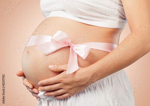 Wallpaper Mural Abdomen. Pregnant belly with pink ribbon Torontodigital.ca