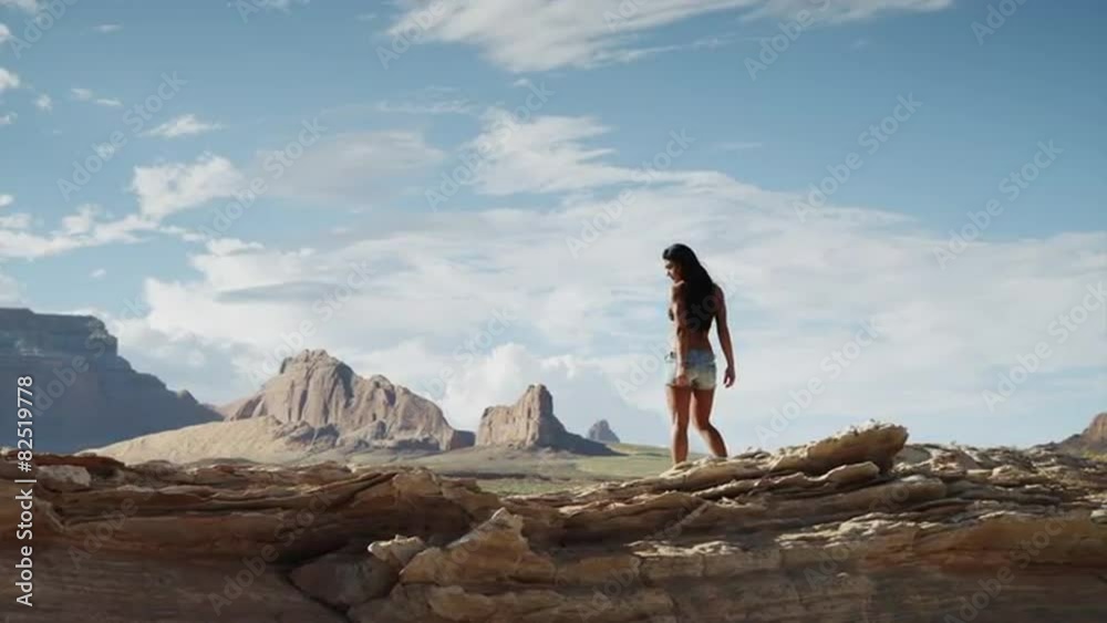 WS DS Young woman walking on rocks near Lake Powell / Utah, USA WS DS Young woman walking on rocks near Lake Powell / Utah, USA