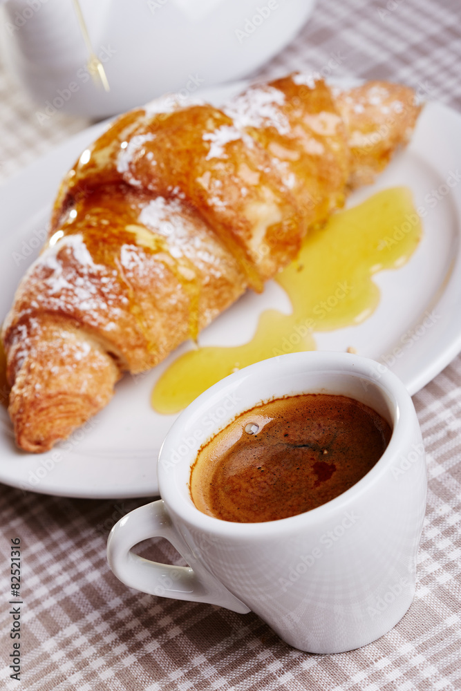 Cup of coffee with croissant