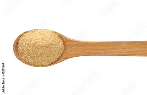 Wooden spoon with dried garlic.