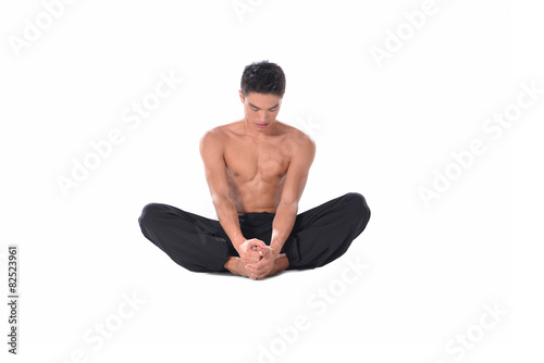 Muscular male model in sportwear sitting on the floor,