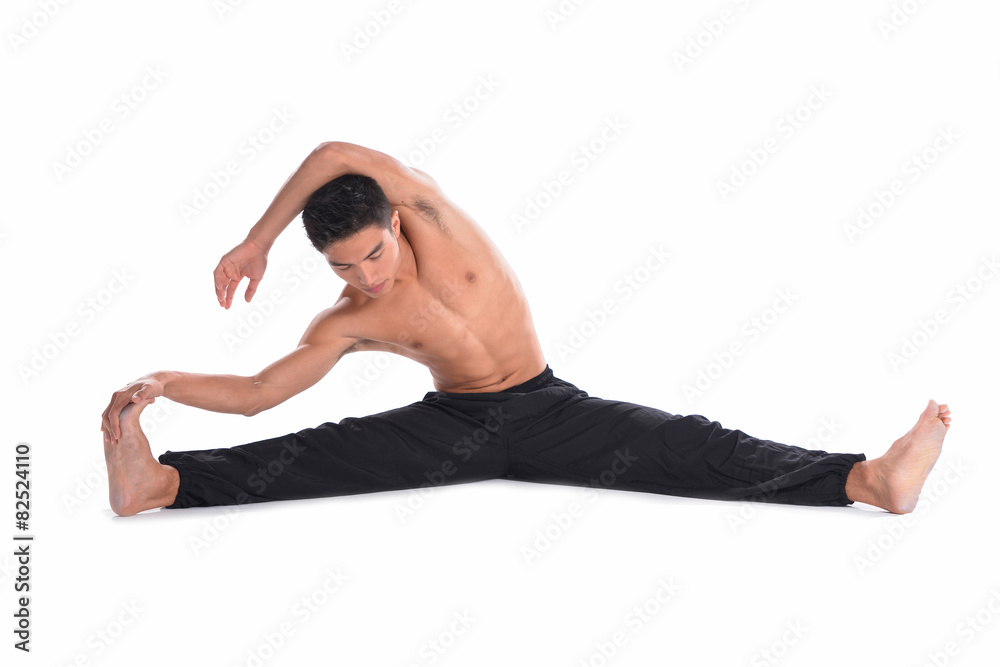 Muscular male model man sitting and making stretching exercises