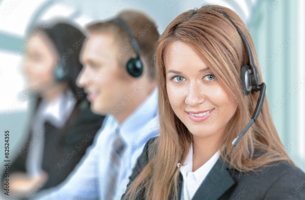 Service. Closeup of a call center employee with headset at Service. Closeup of a call center employee with headset at