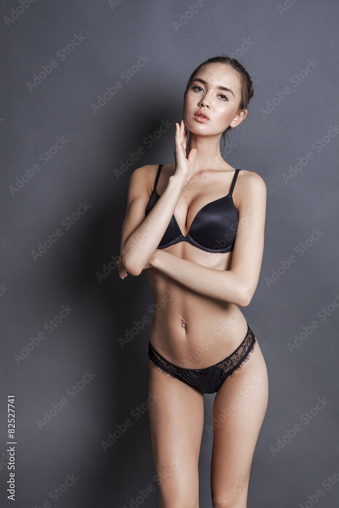 Beautiful and skinny model wearing black lingerie Stock Photo