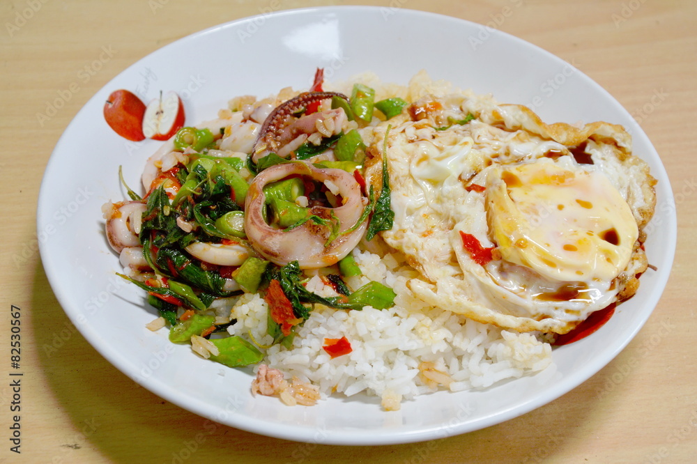 spicy fried squid with basil leaves topping fried egg spicy fried squid with basil leaves topping fried egg