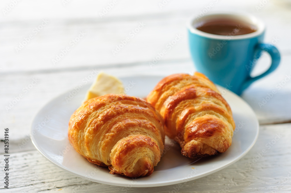 Breakfast with fresh baked croissants, butter and coffee Breakfast with fresh baked croissants, butter and coffee