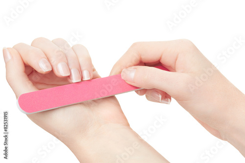 Woman hands manicure with nail file on white, clipping path