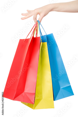 Woman hand holding shopping bags on white, clipping path