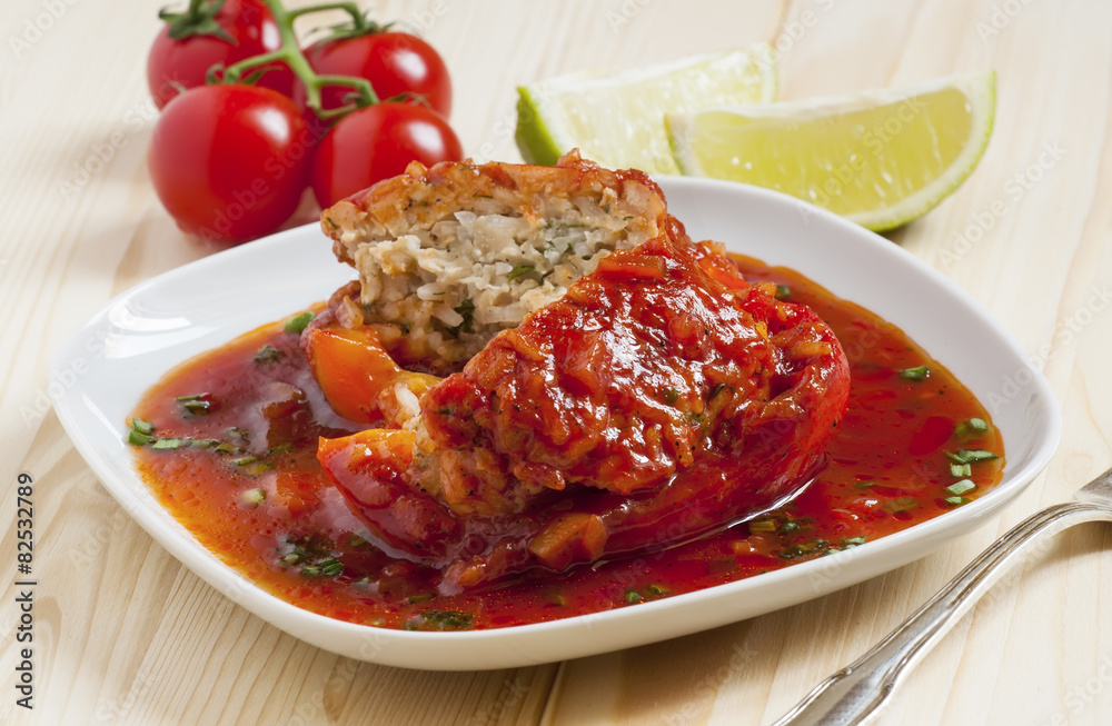 Bell peppers stuffed with meat, rice and sauce on plate Bell peppers stuffed with meat, rice and sauce on plate