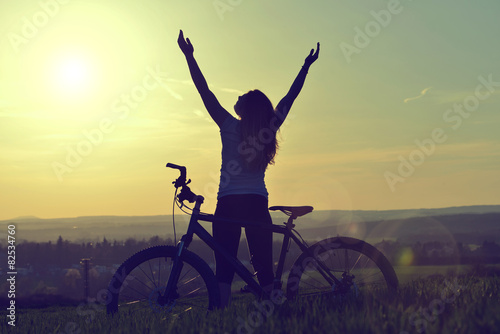 Girl on a bicycle in the sunset