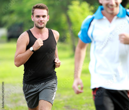 two young sport man jogging together at roadside