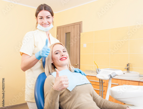 Satisfied female client in dental office