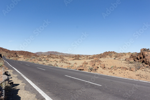 empty street / road / highway in desert / volcanic landscape