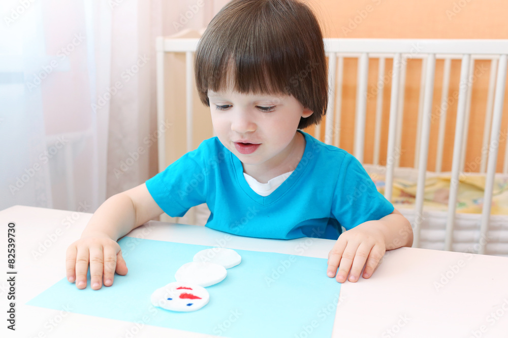 2 years boy makes snowman of cotton pad 2 years boy makes snowman of cotton pad