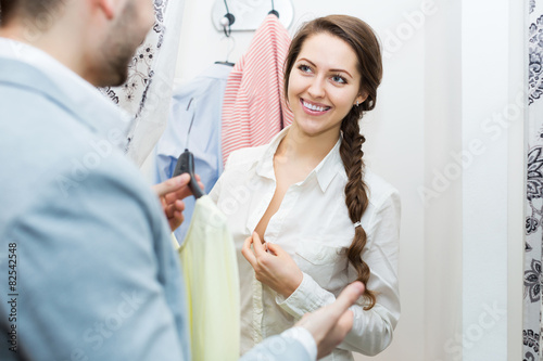 Spouses at boutique changing cubicle