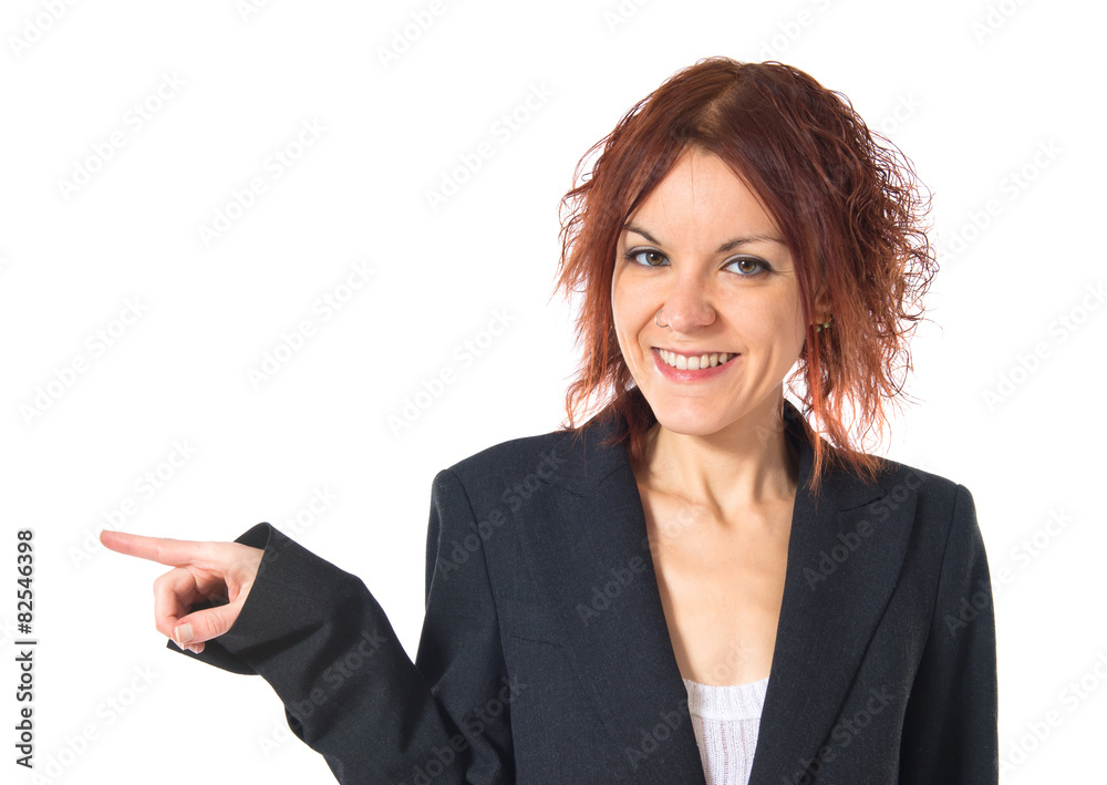 Redhead girl pointing to the lateral