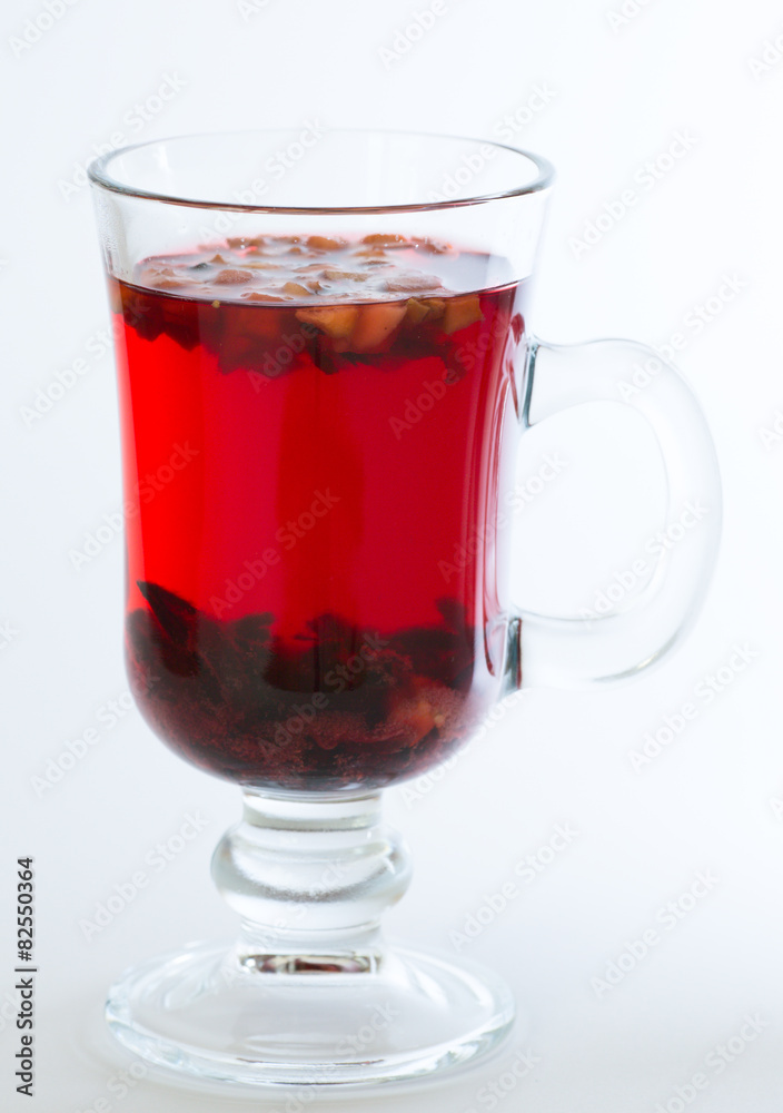 Red flowers fruit tea isolated in the transparent glass Red flowers fruit tea isolated in the transparent glass