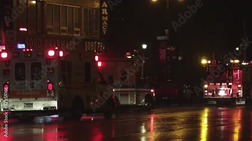 MS PAN Rear view of ambulance and fire truck on street at night, New York City, New York, USA