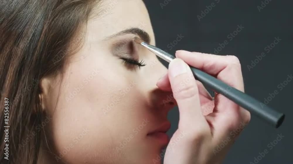 CU TU Makeup artist applying eye shadow on woman's eye / Orem, Utah, USA CU TU Makeup artist applying eye shadow on woman's eye / Orem, Utah, USA