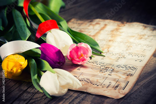 Fototapeta Naklejka Na Ścianę i Meble -  Tulips on a music notes paper