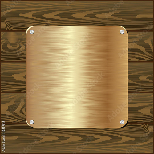 golden plaque on dark wooden wall