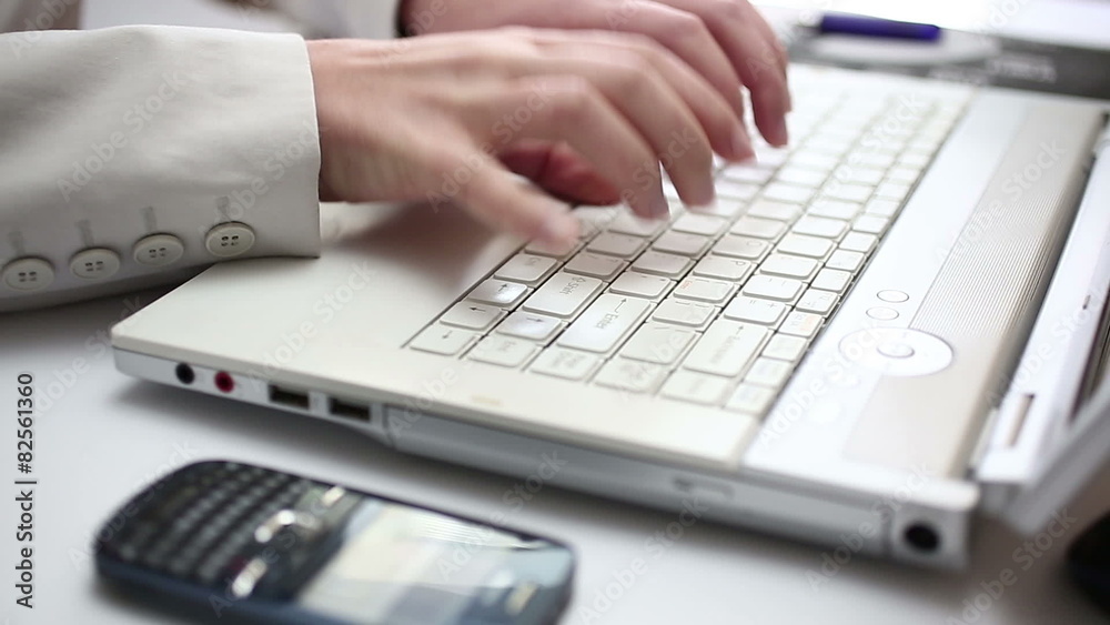 Business person multitasking in office environment Business person multitasking in office environment