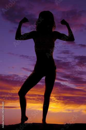 silhouette of a woman in a bikini flexing