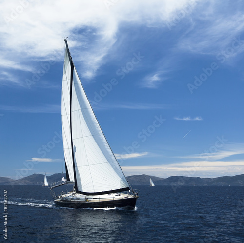 Sailing. Yacht sails with beautiful cloudless sky. Luxury yacht.