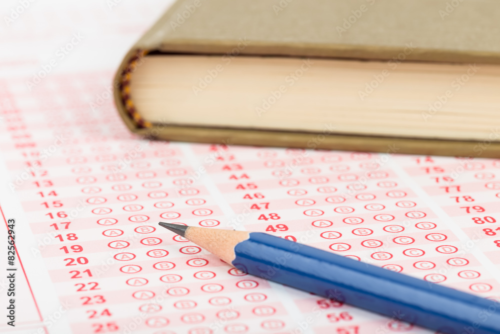Answer sheet with pen and text book Answer sheet with pen and text book