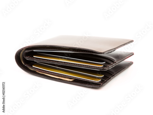 Money in brown leather wallet full of cards on white background