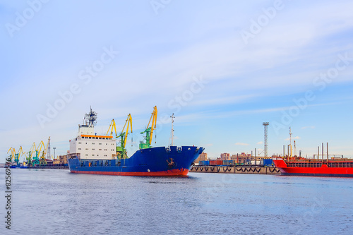 The vehicle is blue on the loading in the Cargo port. Cranes.