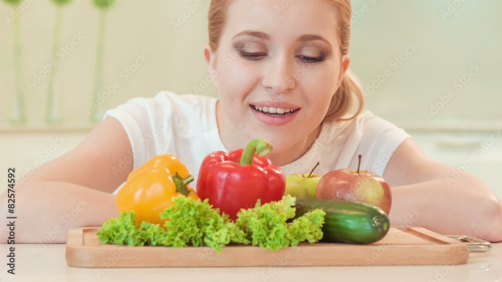 young woman looking with appetite on vegetables young woman looking with appetite on vegetables