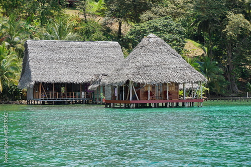 Tropical ecolodge over water with thatched roof
