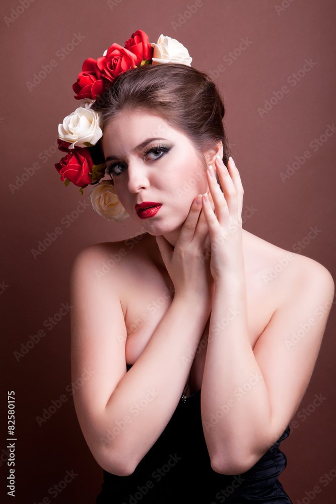 Naklejka premium Girl with flowers in head over brown background