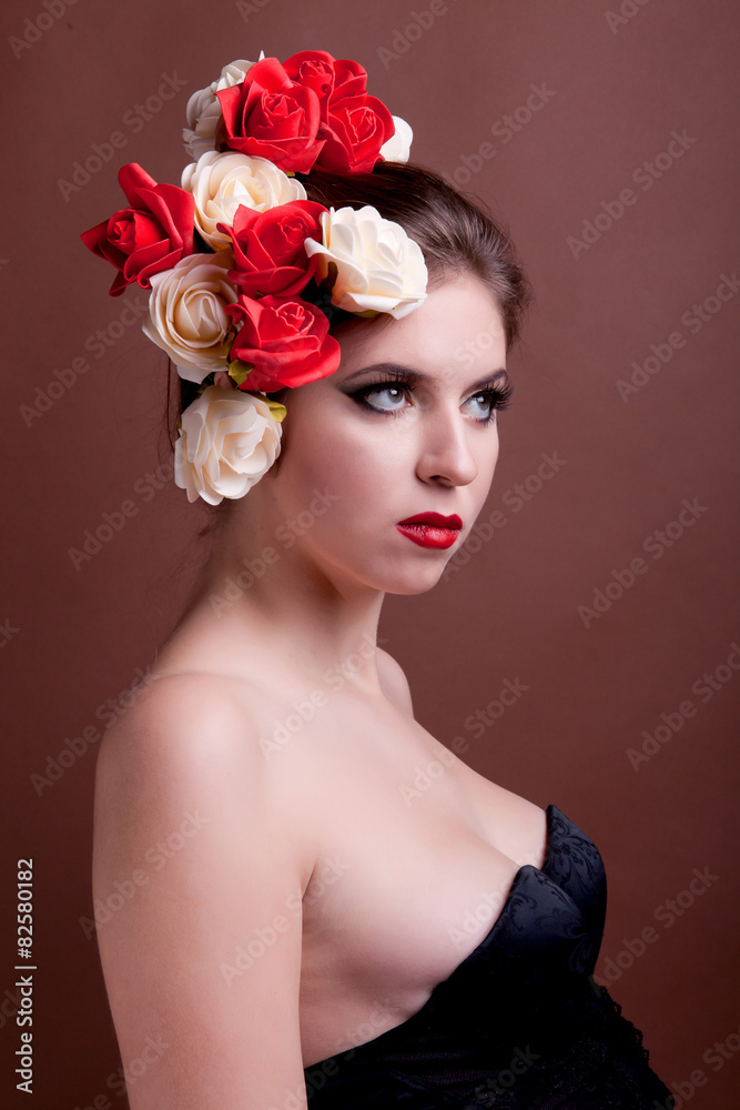 Girl with flowers in head over brown background