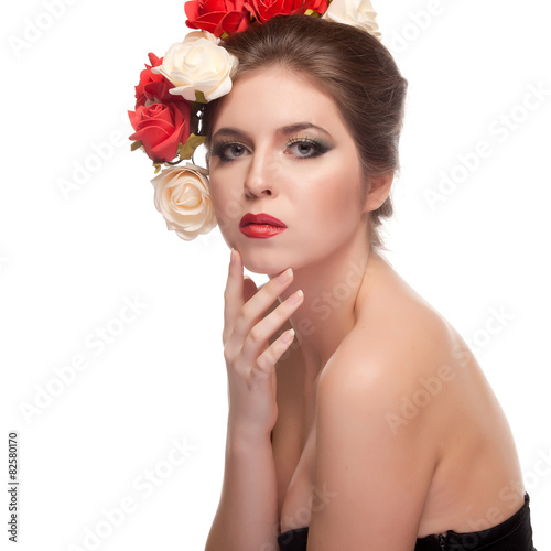Beautiful girl with red lips and flowers in head